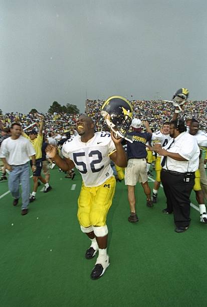 sep-1996-linebacker-rod-payne-of-the-michigan-wolverines-celebrates-picture-id295997